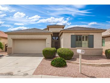 Charming single-story home features low-maintenance landscaping, tile roof, and two car garage at 18131 W Addie Ln, Surprise, AZ 85374