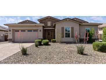 Charming single-story home with desert landscaping and a neutral color palette at 18929 W Windsor Blvd, Litchfield Park, AZ 85340