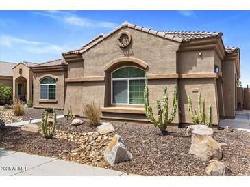 Charming single-story home featuring desert landscaping and a well-maintained stucco facade at 21200 E Camacho Rd, Queen Creek, AZ 85142
