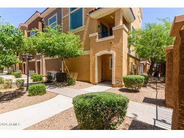 Inviting townhome with well-maintained landscaping, sidewalk, and charming facade at 22125 N 29Th Ave # 137, Phoenix, AZ 85027