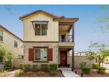 Charming two-story home featuring mixed brick and siding, a small balcony, and a well-maintained front yard at 2540 N Stone Hill Rd, Buckeye, AZ 85396