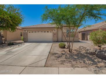 Charming single-story home with a two-car garage and desert landscaping at 38662 N La Grange Ln, San Tan Valley, AZ 85140
