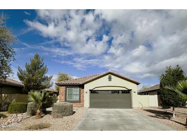Charming single-story home with a two-car garage, low-maintenance landscaping and neutral-tone stucco exterior at 4440 S Leisure Way, Gilbert, AZ 85297