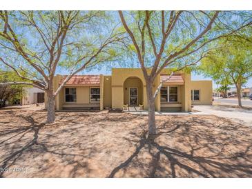 Inviting single-story home with desert landscaping and mature shade trees enhancing curb appeal at 717 W Chilton St, Chandler, AZ 85225