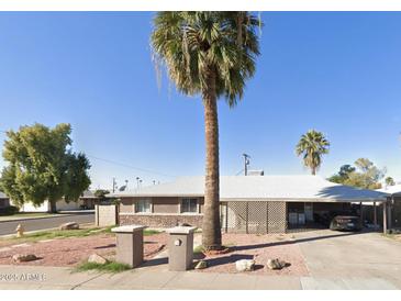 Charming single-story home featuring desert landscaping and a spacious carport at 7202 N 36Th Ave, Phoenix, AZ 85051