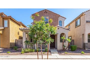 Charming two-story home featuring a landscaped yard and covered entry at 7769 W Bonitos Dr, Phoenix, AZ 85035