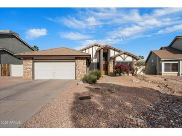 Charming one-story home with a two-car garage and low-maintenance desert landscaping at 11805 N 90Th Way, Scottsdale, AZ 85260