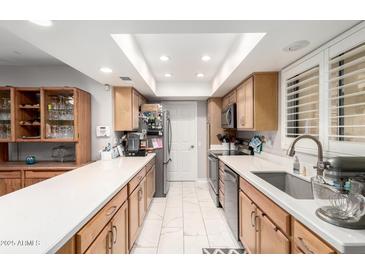 Bright and modern kitchen featuring stainless steel appliances, white countertops and tile floors at 18522 N Mica Dr, Sun City West, AZ 85375