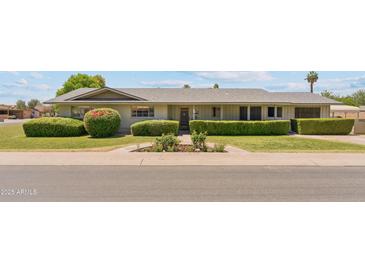 Charming single story home featuring well-maintained landscaping and mature shrubbery at 400 N Jay N St, Chandler, AZ 85225