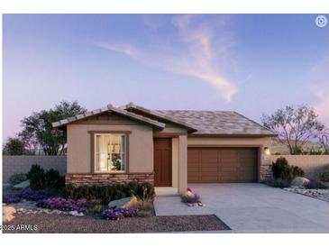 Charming single-story home featuring a stone-accented facade, low-maintenance landscaping and attached two car garage at 5633 S 253Rd Ave, Buckeye, AZ 85326