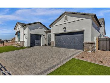 Beautiful home featuring a paver driveway and manicured lawn, adding to its curb appeal at 5749 E Sanford St, Mesa, AZ 85215