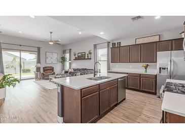 Spacious open-concept layout featuring kitchen, living, and dining areas at 681 W Belmont Red Trl, San Tan Valley, AZ 85143