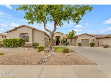 Charming single-story home featuring a well-manicured desert landscape and a spacious three-car garage at 6870 S Justin Way, Chandler, AZ 85249