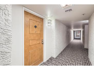 Hallway leading to unit entrance featuring stylish patterned carpet at 7970 E Camelback Rd # 110, Scottsdale, AZ 85251