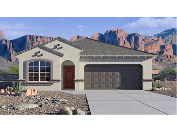 Charming single-story home featuring desert landscaping, a two-car garage, and mountain views at 10544 W Bloch Rd, Tolleson, AZ 85353
