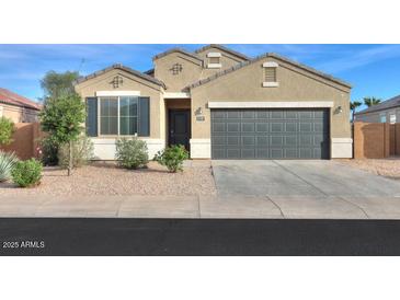 Charming single-story home with a two-car garage and low-maintenance landscaping at 1127 E Tyler Ln, Casa Grande, AZ 85122