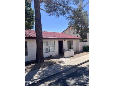 Cozy single-story home with a red tile roof, front walkway, and small landscaped area near the entry at 15610 N 29Th St # 4, Phoenix, AZ 85032