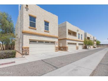 View of exterior of the home and garages at 15818 N 25Th St # 124, Phoenix, AZ 85032