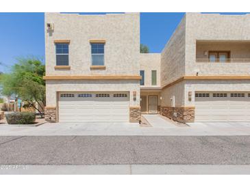 Inviting two-story home boasts a neutral stucco finish and a convenient two-car garage at 15818 N 25Th St # 124, Phoenix, AZ 85032