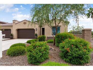 Beautiful home featuring a well-manicured lawn, desert landscaping, and a two-car garage at 16953 W Merrell St, Goodyear, AZ 85395