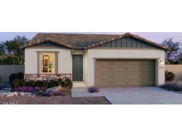 Charming single-story home featuring stone accents, neutral stucco, and a convenient two-car garage at 25138 W Wayland Dr, Buckeye, AZ 85326