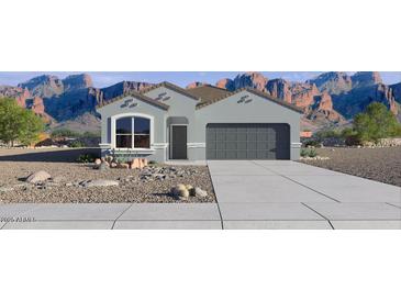 Charming single-Gathering home with a two-car garage and desert landscaping against mountain views at 25455 N 183Rd Dr, Wittmann, AZ 85361
