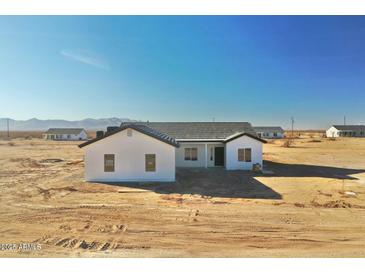 Newly built home featuring modern design, desert landscaping and mountain views at 25852 W White Feather Ln, Wittmann, AZ 85361