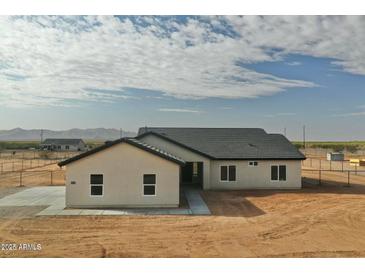 Lovely single-story home showcasing the desert landscape with a neutral palette and stylish architectural design at 25876 W White Feather Ln, Wittmann, AZ 85361