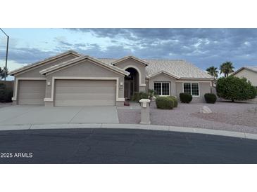 Charming single-story home boasts a three-car garage and well-maintained desert landscaping at 4081 N 156Th Dr, Goodyear, AZ 85395