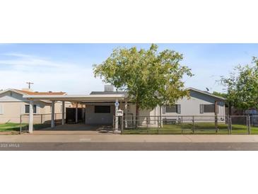 Charming single story home with a mature shade tree and fenced front yard in a quiet residential neighborhood at 6633 N 19Th Dr, Phoenix, AZ 85015