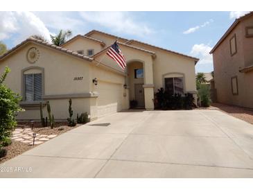 Inviting single-story home with a well-maintained yard, desert landscaping, and neutral stucco exterior at 15507 W Marconi Ave, Surprise, AZ 85374