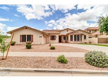 Charming single-story home showcasing well-manicured landscaping and a welcoming entrance at 20423 S 186Th St, Queen Creek, AZ 85142