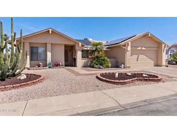 Charming single-story home featuring well-maintained desert landscaping and a two-car garage at 2363 Leisure World --, Mesa, AZ 85206