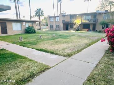 Spacious front yard and outdoor space for relaxation and leisure activities at 2377 W Hazelwood St, Phoenix, AZ 85015