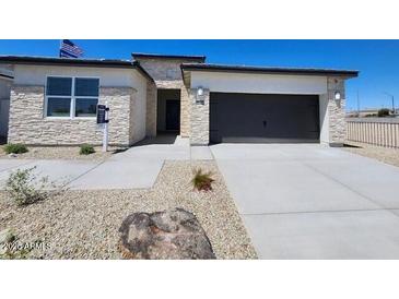 Attractive single-story home with a two-car garage and stone accents at 24105 W Flores Dr, Buckeye, AZ 85326