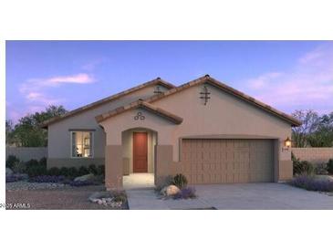Inviting single story home with a two car garage, manicured landscaping, and a welcoming front entrance at 25357 W Bowker St, Buckeye, AZ 85326