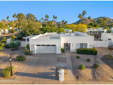 Beautiful single-story home with a well-manicured front yard and attached two-car garage at 39 E Tam Oshanter Dr, Phoenix, AZ 85022