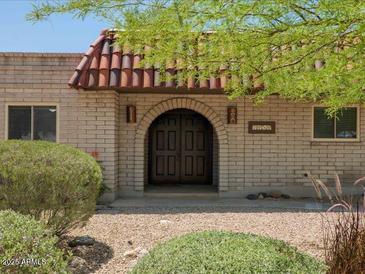Charming brick home with a covered front entry and a striking, arched doorway at 7232 N 22 Nd St, Phoenix, AZ 85020