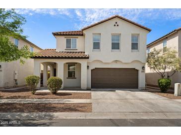 Charming two-story home with a well-maintained lawn and a two-car garage, enhancing curb appeal at 737 E Harwell Rd, Phoenix, AZ 85042