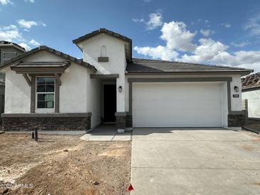 Charming single-story home featuring a two-car garage, stone accents, and low-maintenance landscaping at 7428 W Buckhorn Trl, Peoria, AZ 85383