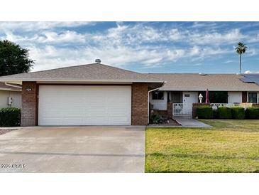 Single level home boasts mature landscaping, two car garage and neutral color palette at 9606 W Long Hills Dr, Sun City, AZ 85351