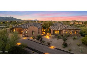 Stunning exterior elevation showcasing the home's architecture, desert landscaping, and inviting entryway at 9936 E Winter Sun Dr, Scottsdale, AZ 85262
