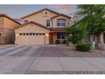 Charming two-story home featuring a well-manicured front yard, two car garage, and inviting front porch at 1721 E Cielo Grande Ave, Phoenix, AZ 85024