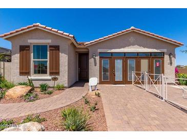 Charming single-story home with well-maintained landscaping and a welcoming front entrance at 17650 W Bajada Rd, Surprise, AZ 85387
