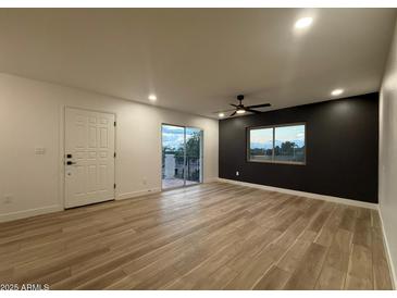Bright living room with wood floors, ceiling fan, and sliding glass doors at 1916 W Morningside Dr # 111, Phoenix, AZ 85023