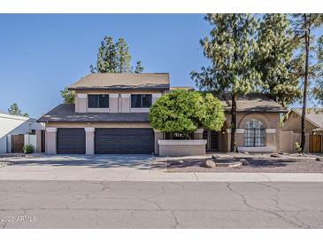 Charming two-story home featuring a three-car garage and a well-maintained front yard at 1927 E Ranch Rd, Tempe, AZ 85284