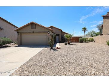 Charming single-story home featuring a two-car garage, gravel landscaping, and a desert-friendly yard at 20802 N 7Th Pl, Phoenix, AZ 85024