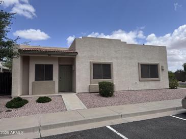 Charming single-story home featuring a well-maintained front yard with desert landscaping, a tiled roof and a light-colored exterior at 2300 E Magma Rd # 91, San Tan Valley, AZ 85143