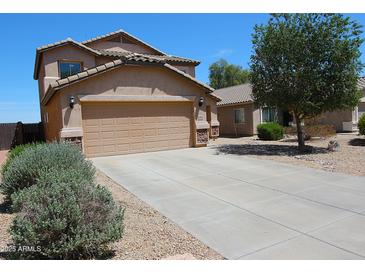 Two-story home featuring a two-car garage, low maintenance desert landscaping, and a tile roof at 2434 E San Manuel Rd, San Tan Valley, AZ 85143