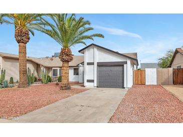 Charming single-story home featuring a grey garage door, well-maintained landscaping, and inviting curb appeal at 3026 W Ross Ave, Phoenix, AZ 85027
